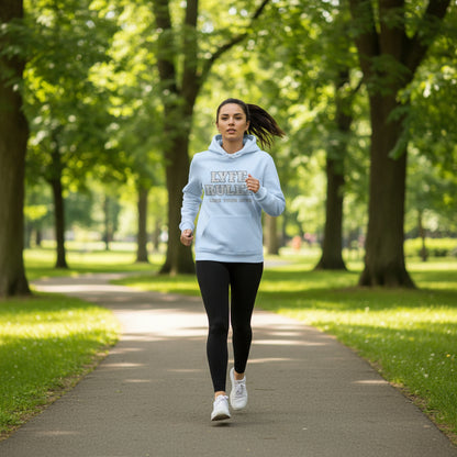 create an image of a woman jogging through the park wearing this hoodie